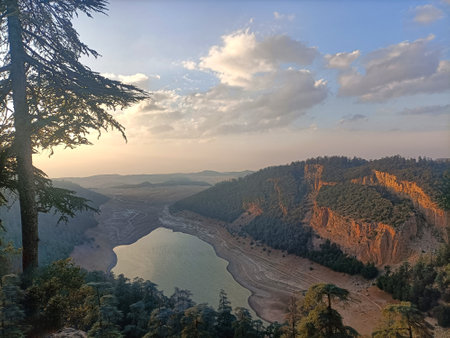 The sun sets gently over the serene lakes at Aguelmam Azegza, nestled in the heart of the Moroccan...