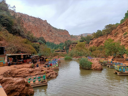 Colorful pedal boats floating on the river at the base of the scenic ouzoud waterfalls in morocco, offering a unique perspective of the natural wonderの写真素材