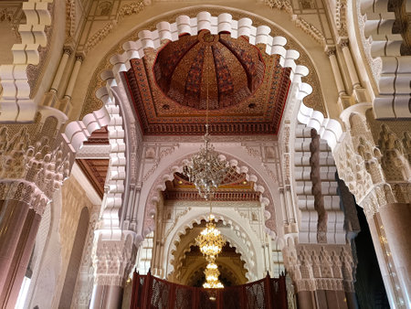 The mesmerizing interior of hassan ii mosque showcases stunning islamic architecture with ornate arches, a beautifully decorated ceiling, and magnificent chandeliersの写真素材