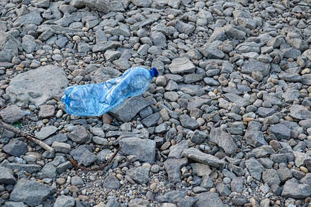 Plastic bottle on the shore plastic trash ocean beach sea shore polluted environmental dirt dirty river water bottle recycling polluted pollution unhygienic danger ecologyの写真素材