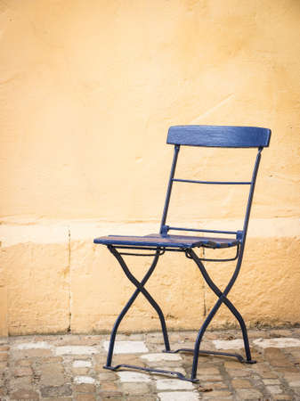 old folding chair at a backyard in rome - nice background with space for textの写真素材
