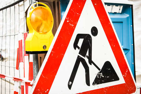 men at work sign at a road construction siteの写真素材