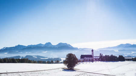 bavarian church near rosenheim - at the background the european alpsの写真素材