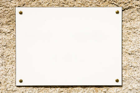 blank sign at a wall - nice background with space for textの写真素材