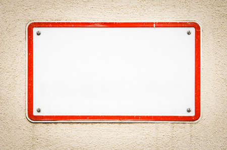blank sign at a wall - nice background with space for textの写真素材