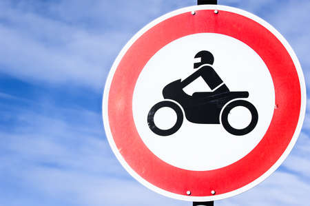 road closed for motorbikes sign in front of skyの写真素材
