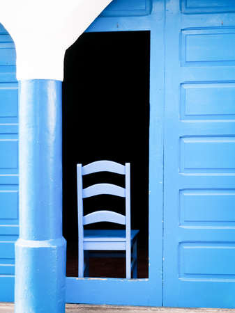 blue chair at a doorの写真素材