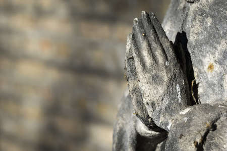 praying hands of an antique statueの写真素材