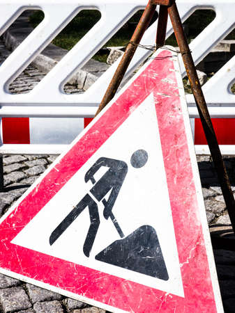 men at work sign at a construction siteの写真素材
