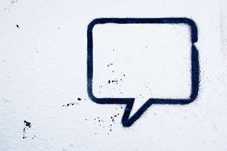 speech bubble at a wall - space for textの写真素材