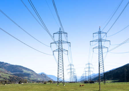 modern electricity pylon in front of blue sky