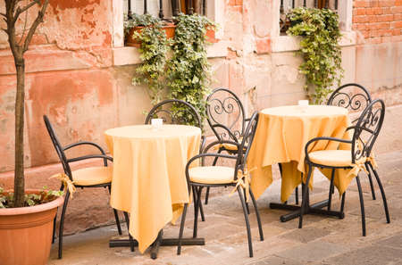 table and chairs at a restaurant in italyの写真素材