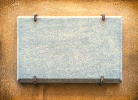 old blank sign at a wallの写真素材