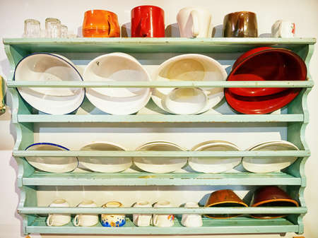 old wooden rack with dishwareの写真素材
