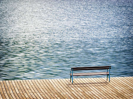 old wooden bench at a lake