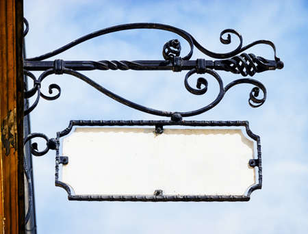 beautiful old store sign in front of skyの写真素材