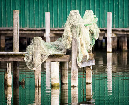 Fishing net on pier with reflections