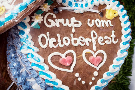 typical souvenir at the oktoberfest in munich - a gingerbread heartの写真素材