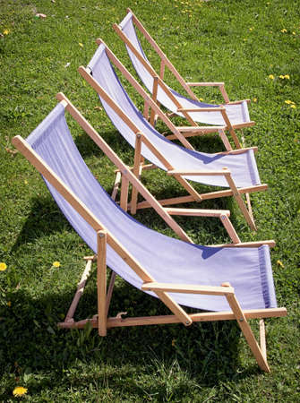 three lounge chairs at a meadow