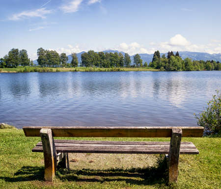 old wooden bench at a lakeの写真素材