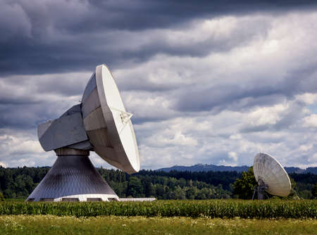 two radio telescopes at a fieldの写真素材