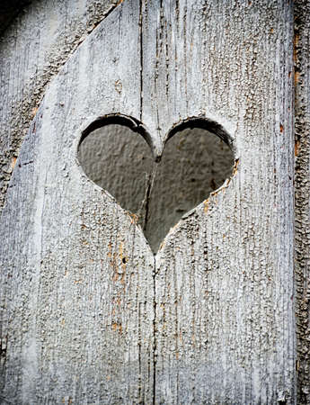 wooden heart at an antique restroom-doorの写真素材