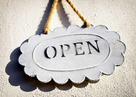 old open sign at a wall