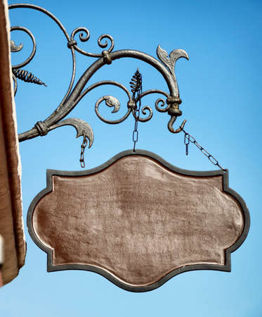 beautiful old store sign in front of skyの写真素材