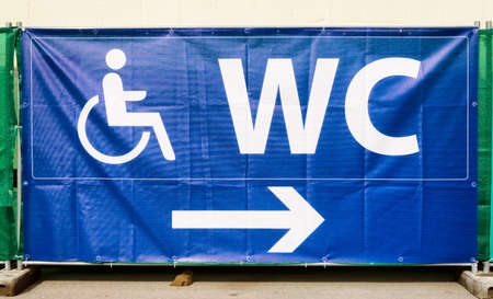 disabled restroom sign at a fenceの写真素材