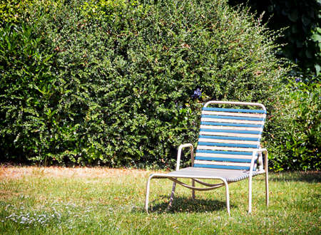 old lounge chair at a meadowの写真素材