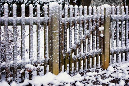 fence in winter with snowの写真素材