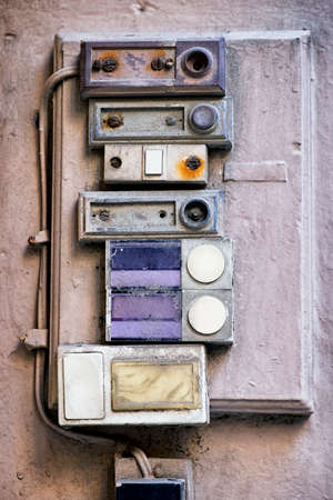 rundown old bell buttons at a wall