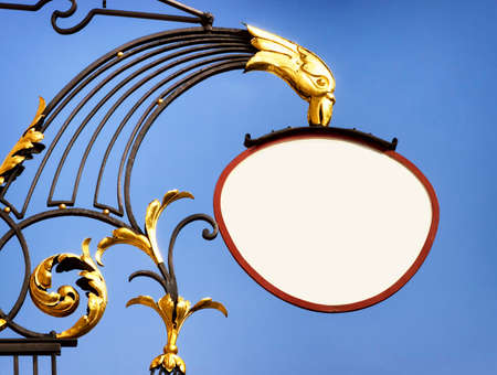 beautiful old store sign in front of skyの写真素材