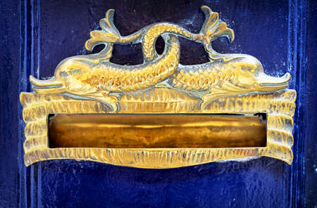 old mail slot at a doorの写真素材