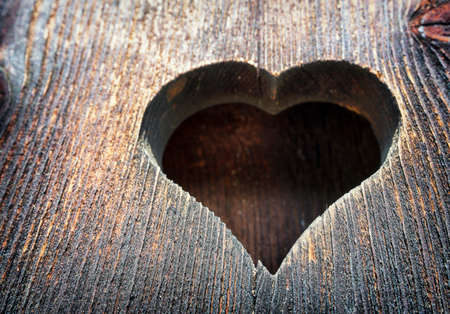 wooden heart at an antique restroom-doorの写真素材