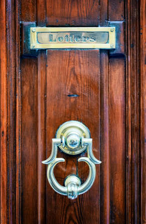 old mail slot at a door