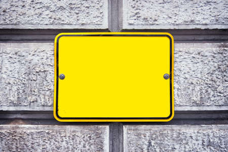 blank sign at a wall - background with space for textの写真素材
