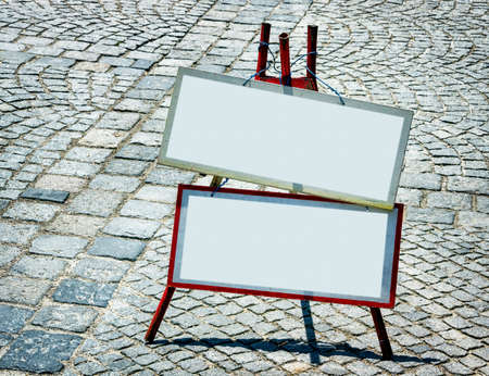 blank signs and cobblestone - nice background with space for text