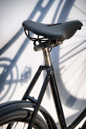 old bike and the shadow on a wallの写真素材