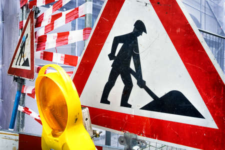 men at work sign at a construction siteの写真素材