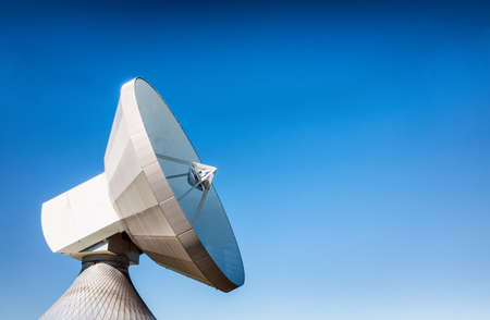 satelite dish in front of blue skyの写真素材