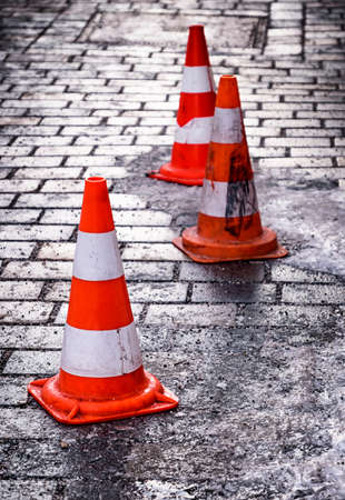 traffic cone at a sidewalk in winterの写真素材