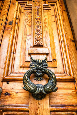 old doorknocker at a doorの写真素材