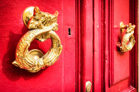 old doorknocker at a doorの写真素材