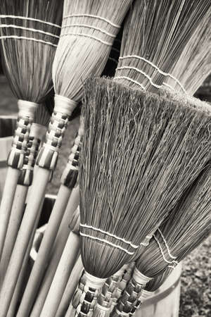 group of old fashioned brooms