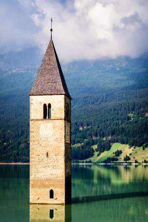 famous historic bell tower at the reschenpass - italy