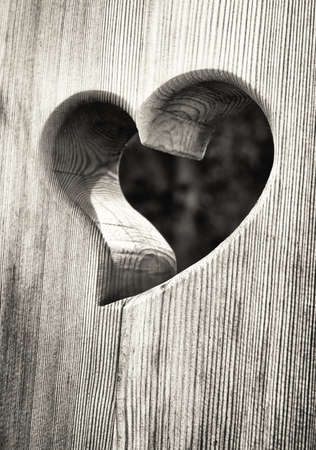 wooden heart at an antique restroom-doorの写真素材