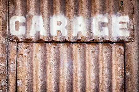 old garage sign at a wallの写真素材