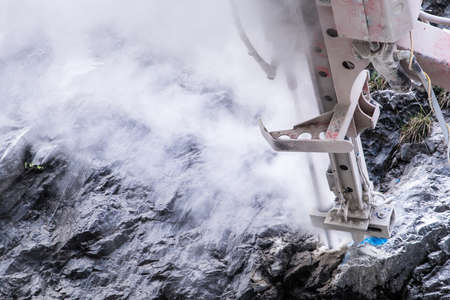 working rock drill at a mountainの写真素材