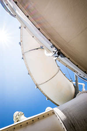 old water slide in front of blue sky